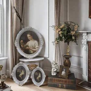 Detailed view of French vintage Rococo resin carved oval picture frames, elegant gold-painted decor.