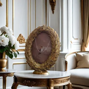 Detailed view of vintage gold resin oval photo frame, elegant desk decor for living room.