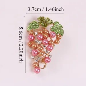 Detailed view of an elegant grape brooch with pink pearls and green crystal leaves