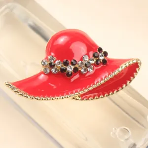 Detailed macro view of a stylish red enamel hat brooch with sparkling rhinestones