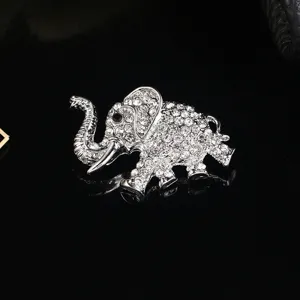 Detailed macro view of a sparkling silver elephant brooch encrusted with clear rhinestones