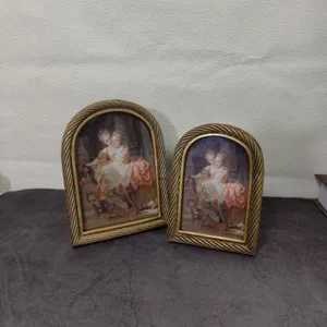 Pair of vintage European arch-shaped gold resin picture frames with twisted borders