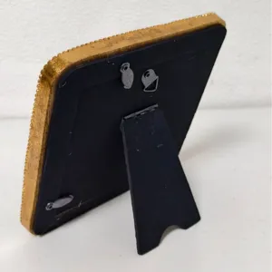 Back view of vintage gold carved picture frame with easel stand and hanging hooks