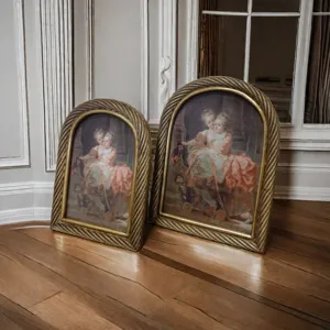 Close-up of vintage European arched golden picture frames with twisted rope border texture