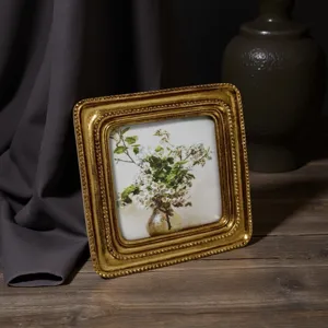 Vintage European gold embossed square picture frame featuring retro floral oil painting
