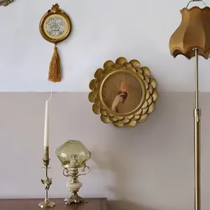 Ornate vintage gold circular resin photo frame with intricate relief carving details