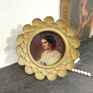 Detailed macro view of a vintage golden resin carved round photo frame with a portrait