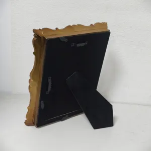Detailed back view of vintage gold photo frame featuring velvet backing and hanging hardware