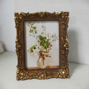 Detailed view of ornate gold vintage picture frame with intricate baroque style carvings