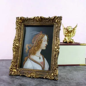 Ornate vintage gold photo frame featuring a classic Renaissance portrait tabletop decor