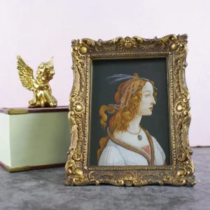 Elegant ornate gold vintage picture frame featuring a classical portrait on display