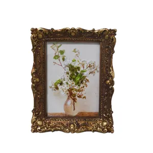 Ornate vintage bronze photo frame with a classical floral still life art print