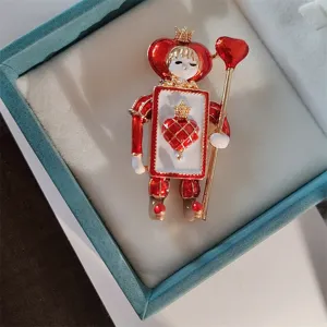 Detailed macro view of a vintage enamel heart soldier brooch resting in a teal gift box
