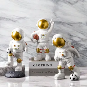 Creative astronaut figurines with soccer and basketball, modern home office desktop ornaments.