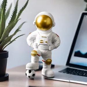 Detailed shot of an astronaut figurine stepping on a soccer ball, modern desktop decor.