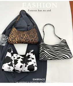 Selection of animal print underarm bags in leopard, zebra, and cow patterns for women