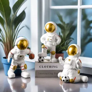 Three creative astronaut figurines with golden visors in basketball and soccer sports poses.