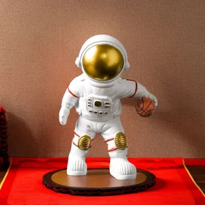 Detailed view of white astronaut figurine holding a basketball on wooden base