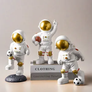 Detailed shot of three creative astronaut figurines with golden visors in various sports poses