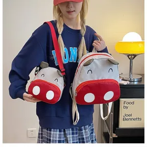 Zweiteiliges Set aus Cartoon-Kuh-Rucksäcken für Kinder, mit Umhängetasche und großem Rucksack.