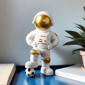 Detailed shot of creative astronaut figurine stepping on a soccer ball for desk decor
