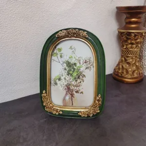Vintage French style resin picture frame with ornate golden rose carvings and art