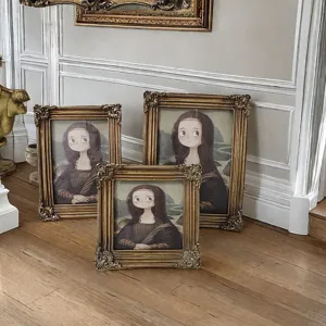Detail of ornate European-style carved resin frames with cartoon Mona Lisa artwork.
