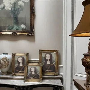 Detailed view of ornate golden carved resin photo frames set in a vintage interior