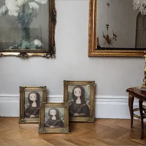 Antique gold ornate resin picture frames displayed in a classic vintage room setting