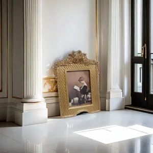 Detailed view of a gold French vintage photo frame leaning against a classical column.