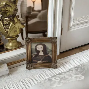 Close-up of ornate gold carved resin picture frame with whimsical cartoon artwork