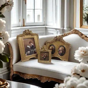 Macro detail of three ornate French vintage gold picture frames set on a luxury sofa