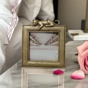Close-up of luxury resin photo frame featuring a vintage bronze leopard sculpture
