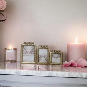 Light luxury resin photo frames with cat figurine on a marble table with candles