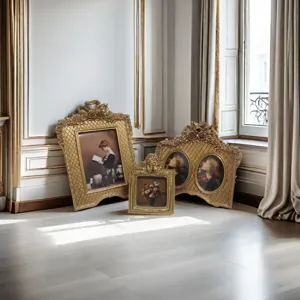 Set of ornate French vintage gold picture frames on a classic parquet floor.