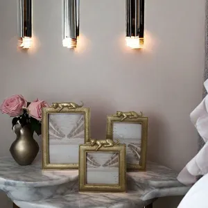 Luxury gold resin photo frames with decorative leopard accents on marble tabletop