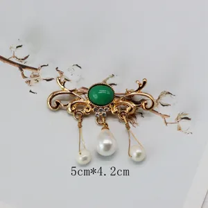Vintage gold-tone brooch with oval green stone and hanging pearls, size 5cm by 4.2cm.