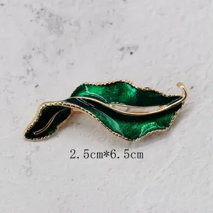 Detailed macro view of vintage green enamel leaf brooch with 2.5x6.5cm size info