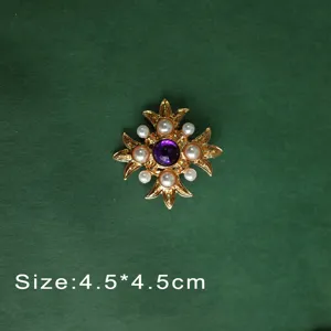 Detail view of a vintage Baroque style brooch with purple gem and pearls, size 4.5x4.5cm