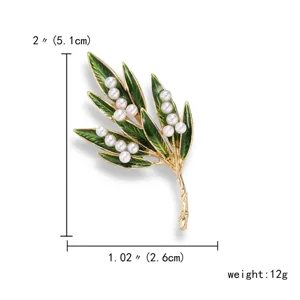 Detail view showing dimensions of a green enamel leaf brooch with white pearls
