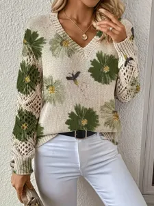 Detail showing elegant bohemian floral sweater with hollow-out knit sleeves and V-neck.