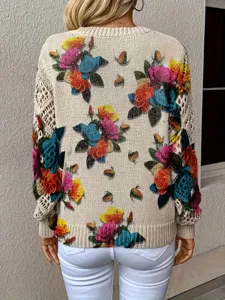 Back view of bohemian floral printed knit sweater with intricate floral patterns and crochet sleeves