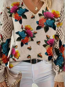 Detail view of an elegant V-neck knit sweater with vibrant bohemian floral print and hollow sleeves