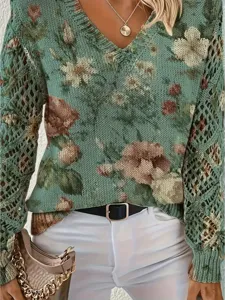 Detailed view of women's bohemian floral print knit sweater featuring V-neck and mesh sleeves