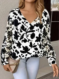 Detailed macro view of white sweater with black floral print and hollow out crochet sleeves