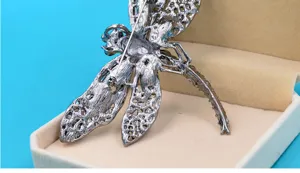 Detailed back view of a vintage dragonfly brooch with secure pin clasp mechanism.