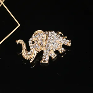 Detailed close-up of a sparkling rhinestone elephant brooch in a luxury gold finish.