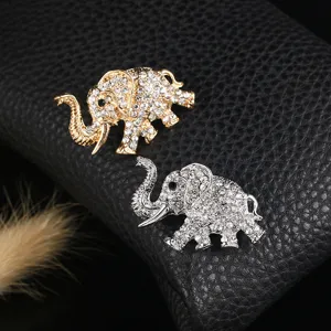 Detail of elegant gold and silver elephant brooches encrusted with sparkling rhinestones