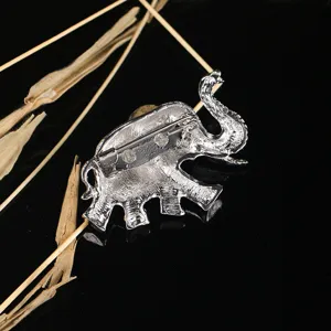 Detail view of the silver-tone Thai elephant brooch showing the back pin mechanism.