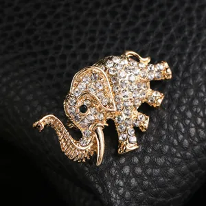 Detailed macro view of a gold-tone elephant brooch paved with sparkling rhinestones